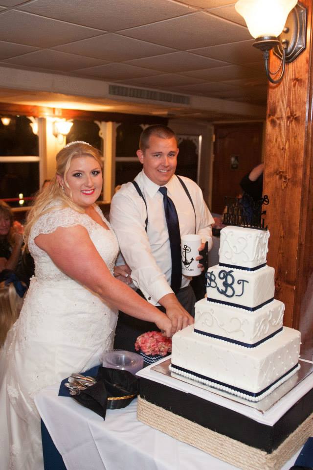 Bride Bailee and her groom cutting their wedding cake on the Star of Knoxville