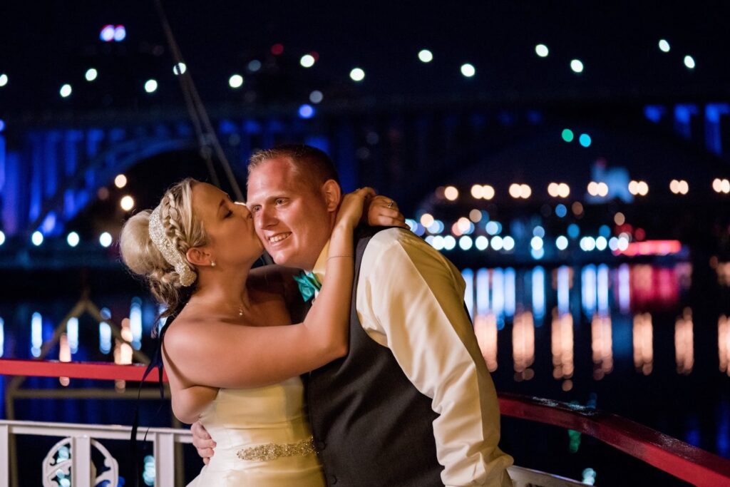 Kissing bride and groom during an evening celebration on the Star of Knoxville